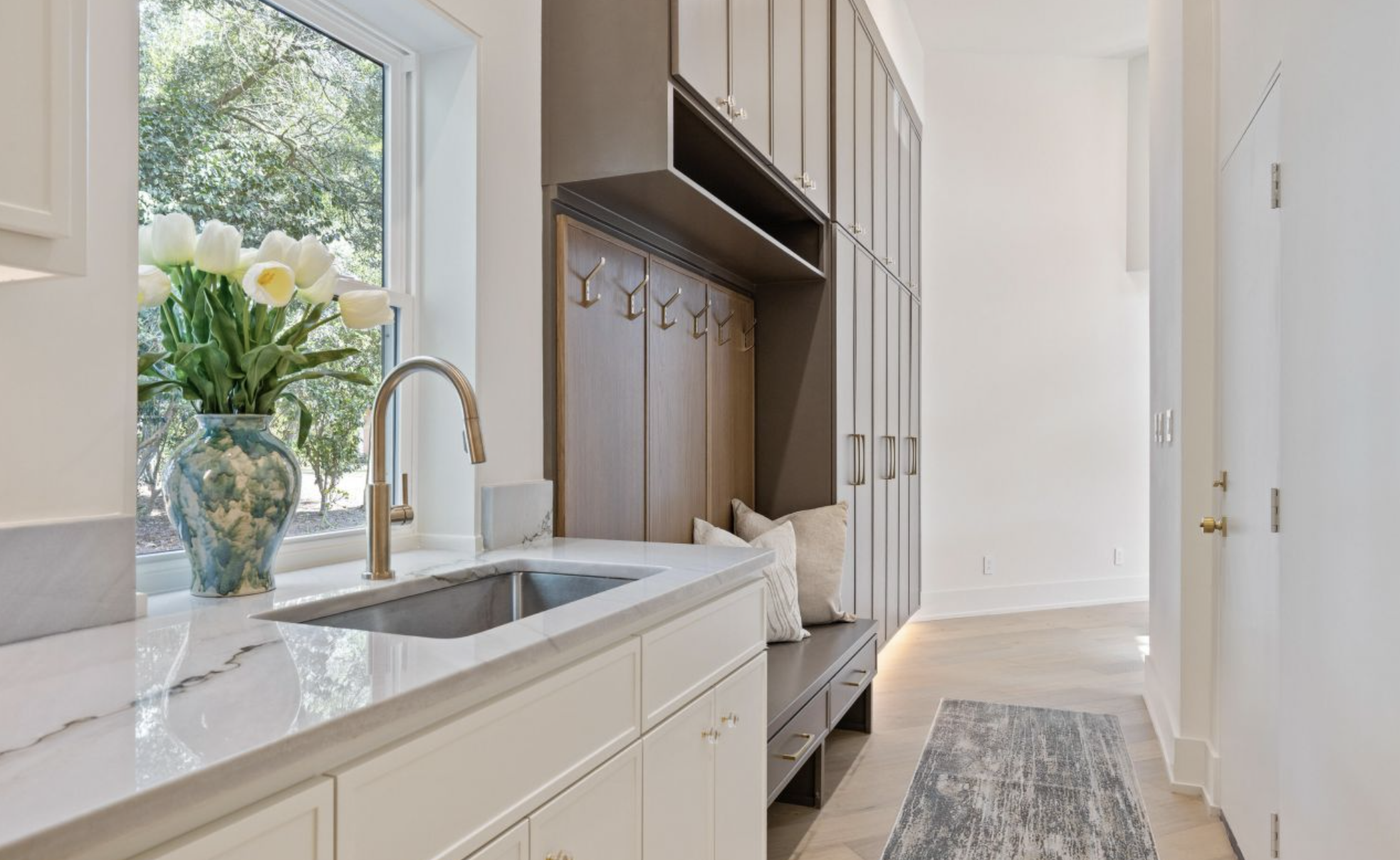 High-end mudroom prep area with built-in storage and quartz counters